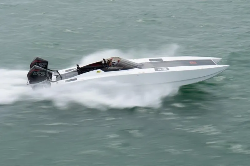 The Image of 2025 HellCat 32 Widebody speedboat racing on water, showcasing sleek design and powerful engines. - 0