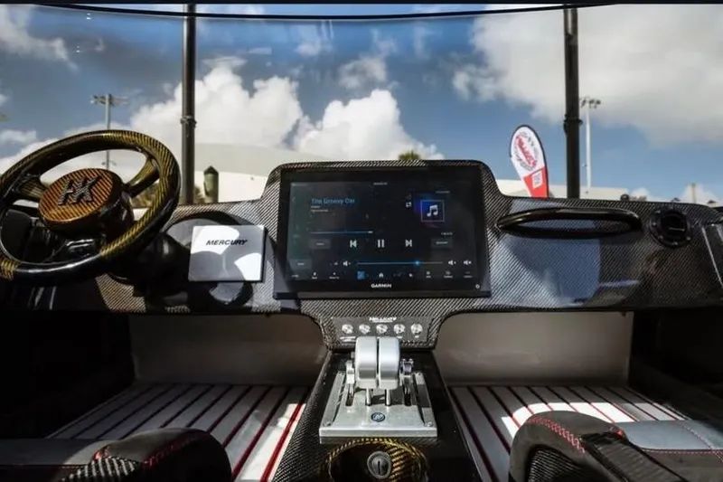 Slide: The Image of Interior of 2025 HellCat 32 Widebody boat with advanced dashboard and steering wheel. - 10