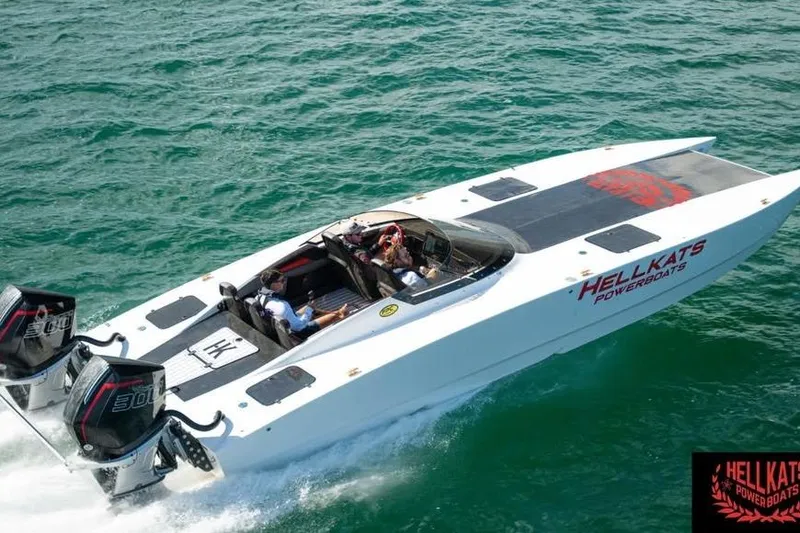 Slide: The Image of 2025 HellCat 32 Widebody powerboat cruising on open water, featuring dual engines. - 2