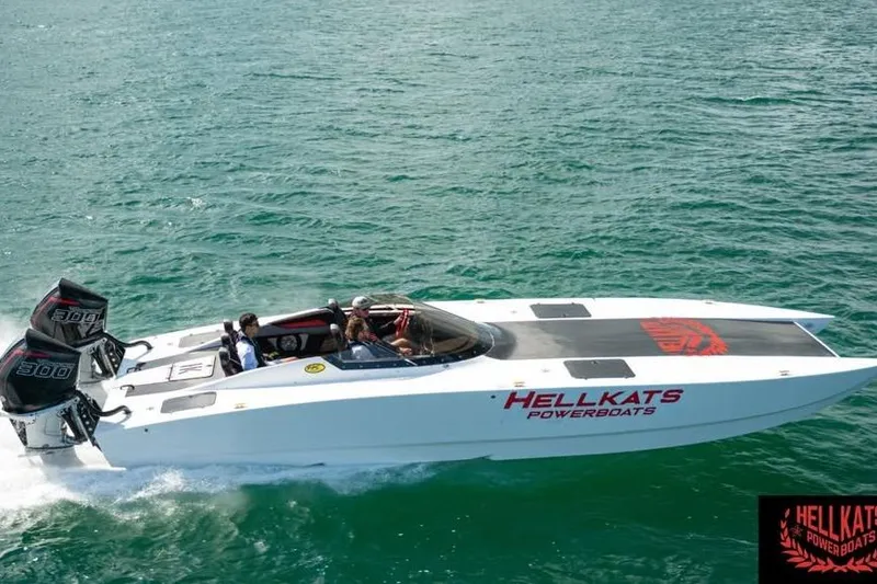 Slide: The Image of 2025 HellCat 32 Widebody powerboat cruising on clear water, featuring dual engines. - 3