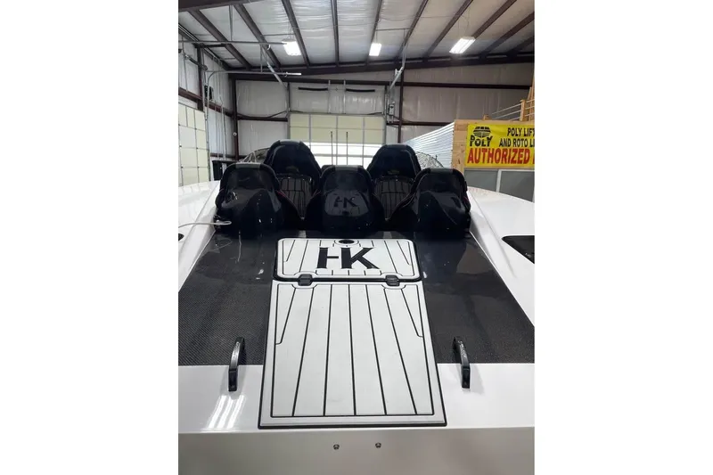 Slide: The Image of 2025 HellCat 32 Widebody boat in a warehouse, featuring sleek design and multiple seats. - 5