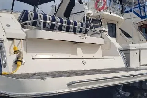 Slide: The Image of 2005 Regal Commodore 3560 IO yacht with striped seating and docked at a marina. - 17