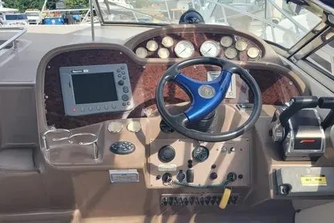 Slide: The Image of 2005 Regal Commodore 3560 IO boat dashboard with steering wheel and navigation controls. - 2