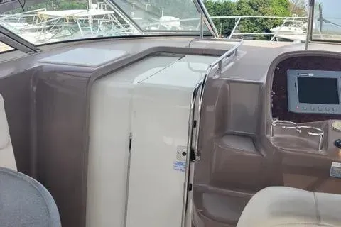 Slide: The Image of 2005 Regal Commodore 3560 IO boat interior with control panel and seating area. - 9