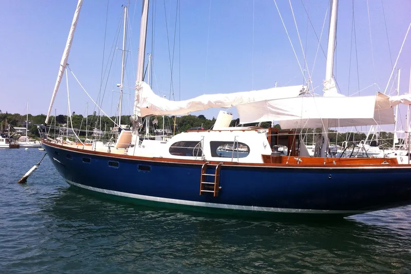 Slide: The Image of 1965 Pearson Countess 44 sailboat with blue hull docked in a marina. - 12