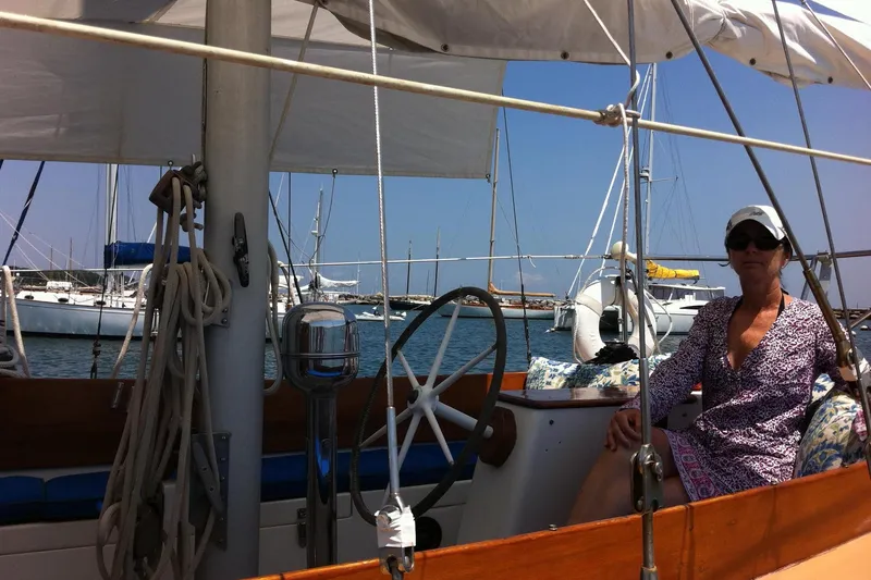 Slide: The Image of Woman relaxing on a 1965 Pearson Countess 44 sailboat in a marina. - 13