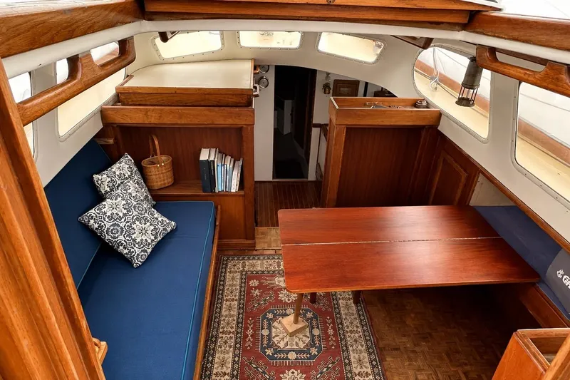 Slide: The Image of Interior of 1965 Pearson Countess 44 sailboat with wooden furnishings and cozy seating area. - 3