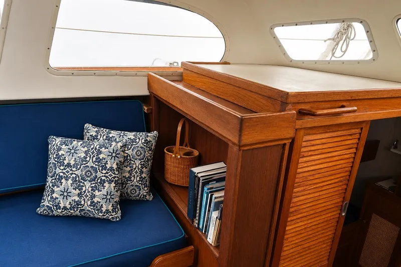 Slide: The Image of Interior of 1965 Pearson Countess 44 yacht with blue cushions and wooden cabinetry. - 4