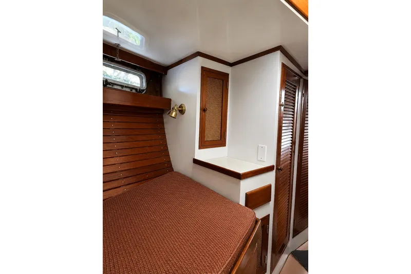 Slide: The Image of Cozy cabin interior of 1965 Pearson Countess 44 sailboat with wood accents and built-in storage. - 7