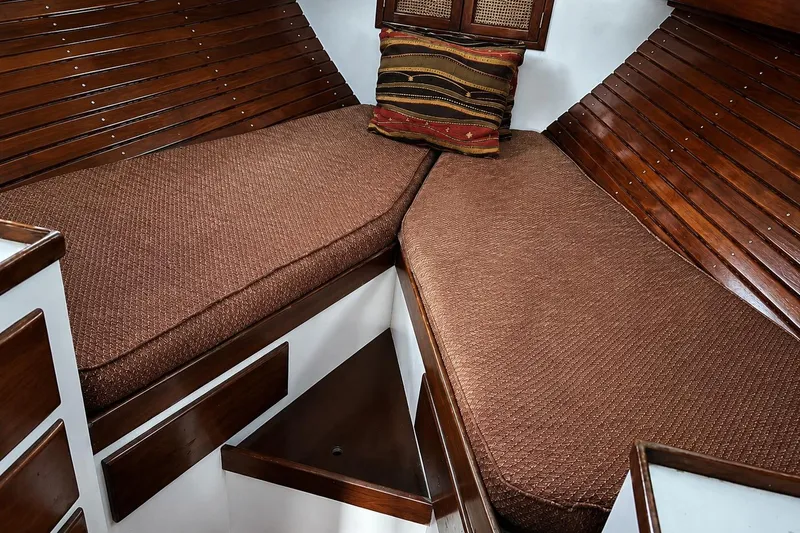 Slide: The Image of Cozy cabin interior of 1965 Pearson Countess 44 sailboat with wooden paneling and cushions. - 8