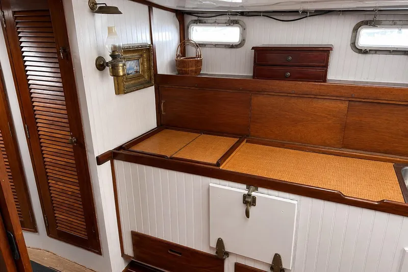 Slide: The Image of Interior of a 1965 Pearson Countess 44 sailboat with wooden cabinetry and vintage decor. - 9