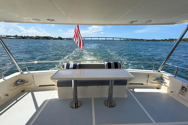 Slide: The Image of Aft deck of 2018 Marlow 53E yacht with table, seating, and ocean view. - 10