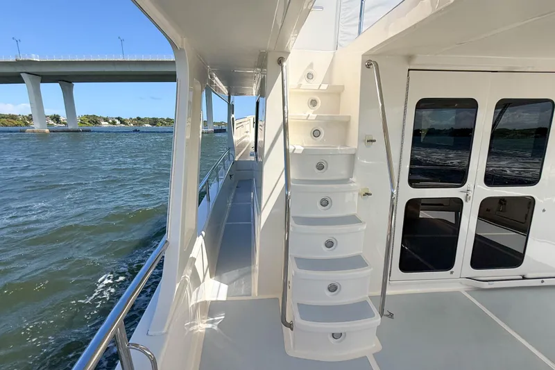 Slide: The Image of Side view of 2018 Marlow 53E yacht with stairs and waterway backdrop. - 13