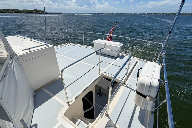 Slide: The Image of Flybridge of 2018 Marlow 53E yacht with ocean view and safety equipment. - 14