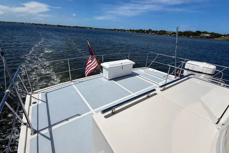 Slide: The Image of Marlow 53E yacht deck with American flag, cruising on open water, 2018 model. - 15