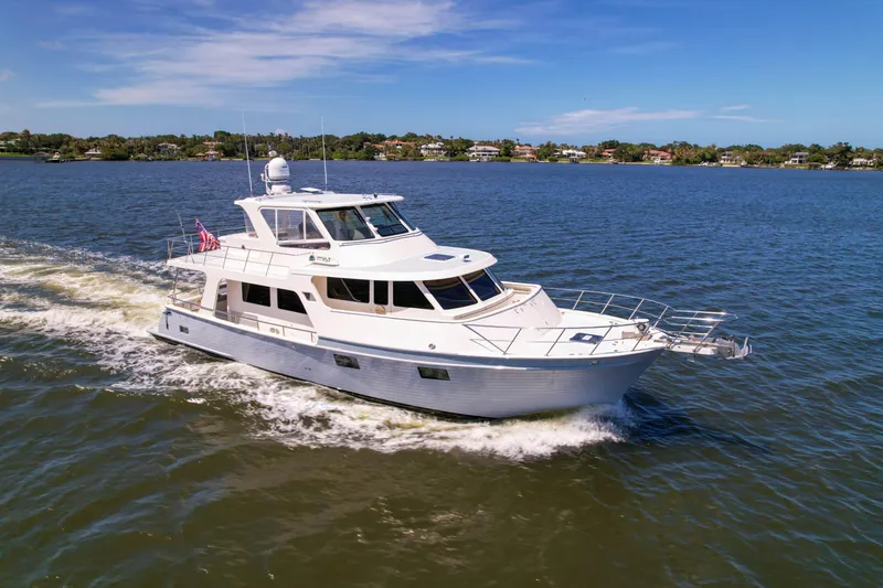 Slide: The Image of A 2018 Marlow 53E yacht cruising on a sunny day in calm waters. - 2