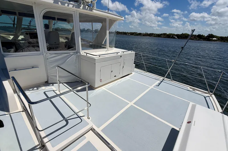 Slide: The Image of Marlow 53E 2018 yacht deck with railing, overlooking serene water and blue sky. - 20