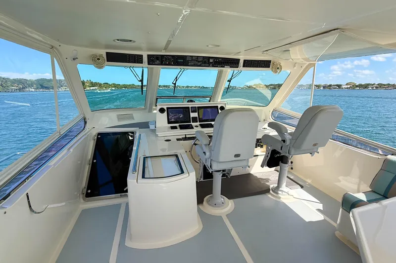 Slide: The Image of Interior view of 2018 Marlow 53E yacht cockpit with dual captain chairs and navigation equipment. - 21