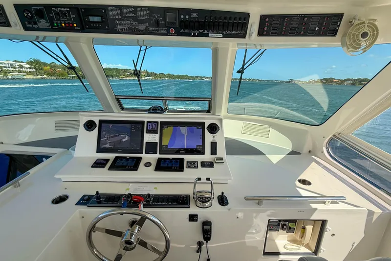Slide: The Image of Cockpit view of 2018 Marlow 53E yacht with navigation screens and steering wheel. - 22