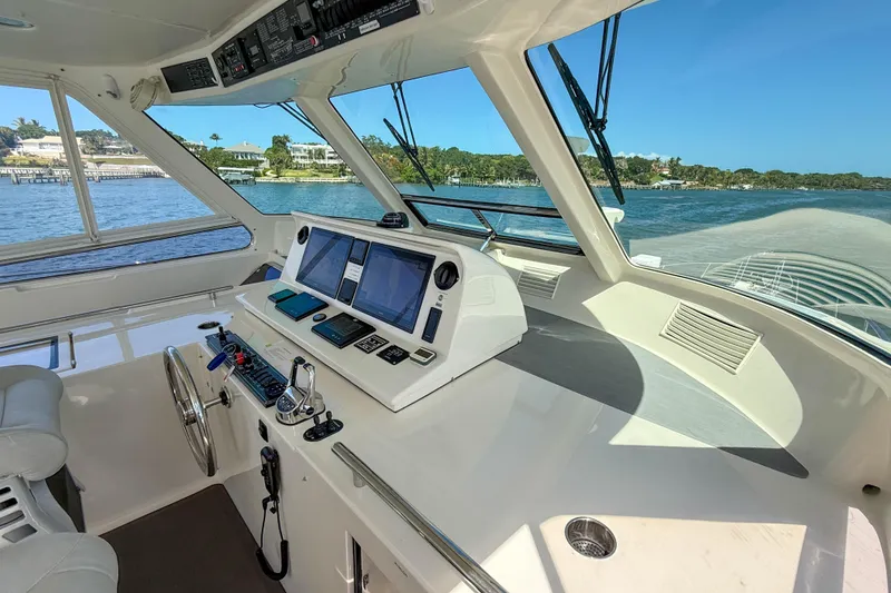 Slide: The Image of Cockpit of 2018 Marlow 53E yacht with navigation controls and scenic water view. - 27