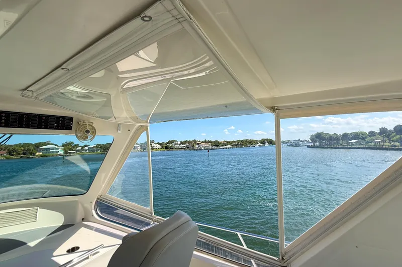 Slide: The Image of Cockpit view from a 2018 Marlow 53E yacht overlooking a serene waterfront. - 28