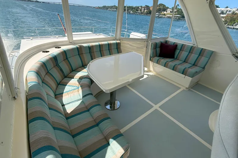 Slide: The Image of Luxurious interior of 2018 Marlow 53E yacht with striped seating and scenic water view. - 30