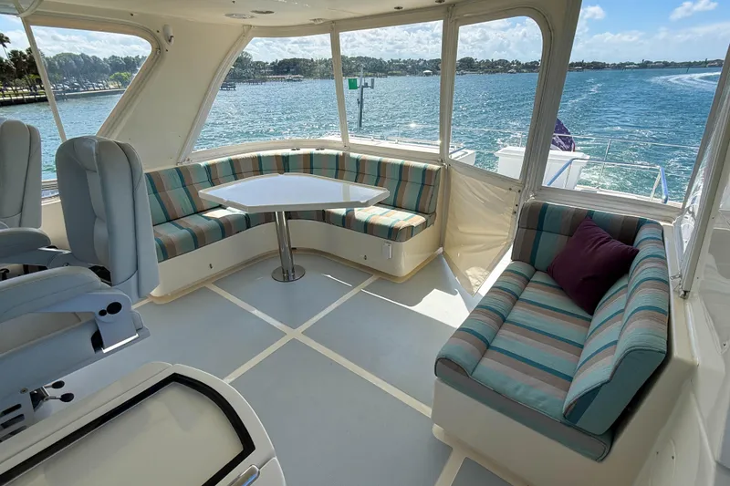 Slide: The Image of Luxurious interior of 2018 Marlow 53E yacht with striped seating and ocean view. - 31