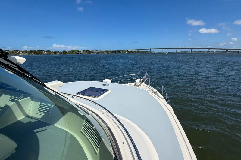 Slide: The Image of Marlow 53E yacht cruising on a sunny day with a bridge in the background. - 33