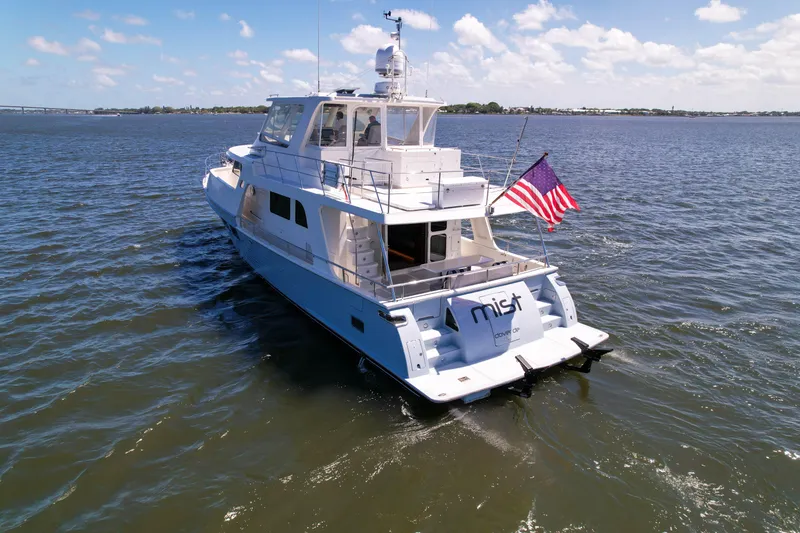 Slide: The Image of A 2018 Marlow 53E yacht named "Mist" cruising on open water under a clear sky. - 4