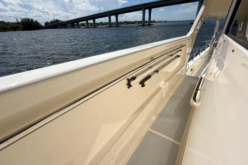 Slide: The Image of Side deck of 2018 Marlow 53E yacht with fishing rods, overlooking water and bridge. - 41