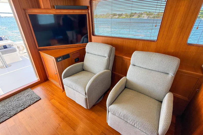 Slide: The Image of Interior of 2018 Marlow 53E yacht with two gray recliners and a flat-screen TV. - 46