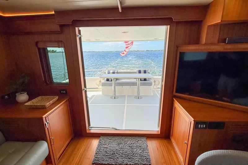 Slide: The Image of Interior view of 2018 Marlow 53E yacht, showcasing elegant wood finish and ocean view. - 48