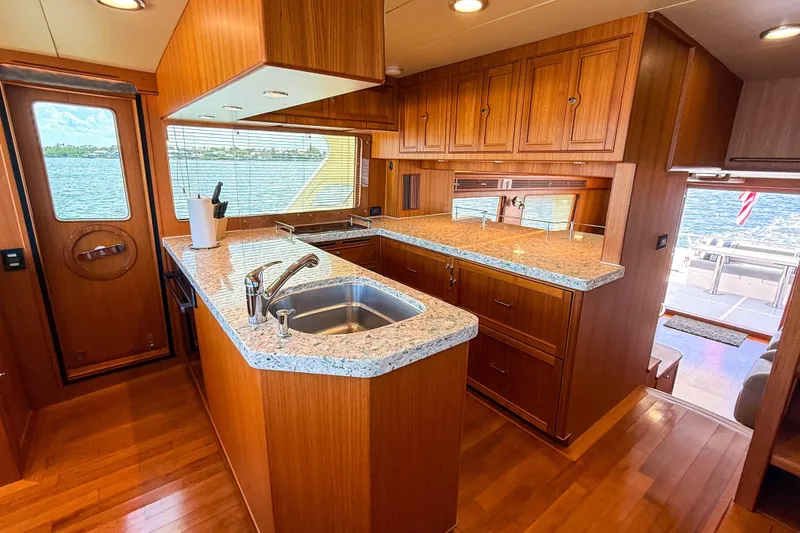Slide: The Image of Luxurious kitchen interior of 2018 Marlow 53E yacht with wooden cabinetry and granite countertops. - 55
