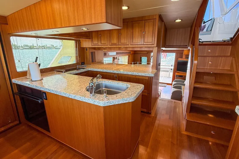Slide: The Image of Luxurious 2018 Marlow 53E yacht interior with modern kitchen and wooden cabinetry. - 57