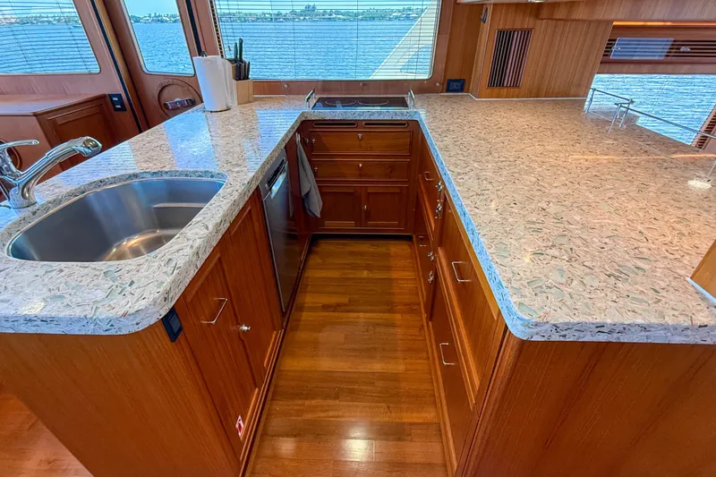 Slide: The Image of Luxurious Marlow 53E 2018 yacht kitchen with elegant countertops and wooden cabinetry. - 59