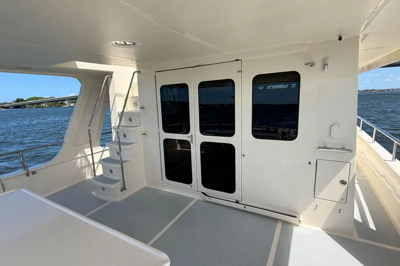 Slide: The Image of 2018 Marlow 53E yacht deck with stairs and ocean view. - 6