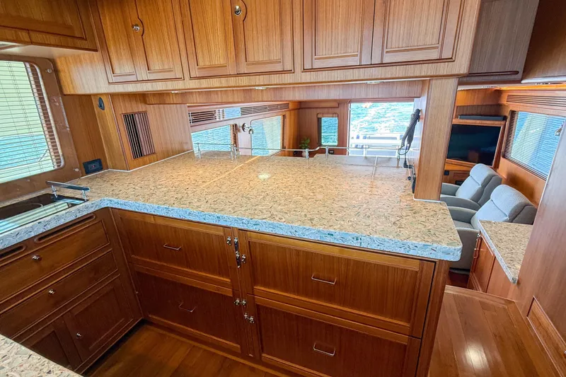 Slide: The Image of Luxurious Marlow 53E 2018 yacht interior with elegant wood cabinetry and spacious seating area. - 60