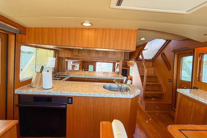 Slide: The Image of Luxurious 2018 Marlow 53E yacht interior with modern kitchen and wooden finishes. - 65