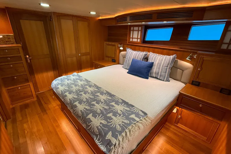 Slide: The Image of Luxurious Marlow 53E 2018 yacht bedroom with elegant wood finish and cozy bedding. - 70