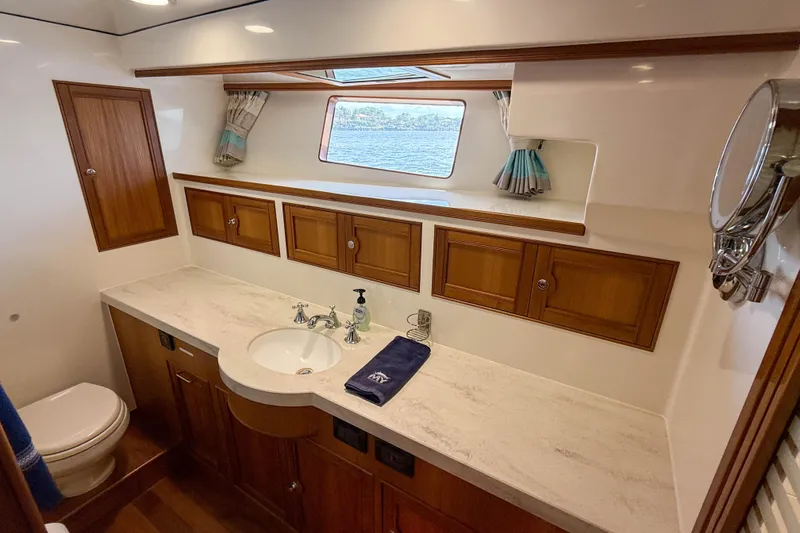 Slide: The Image of Luxurious bathroom interior of 2018 Marlow 53E yacht with wooden cabinets and marble countertop. - 72
