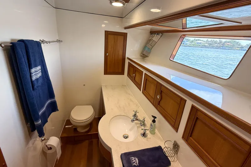 Slide: The Image of Luxurious Marlow 53E yacht bathroom with ocean view, elegant wood accents, and modern fixtures. - 73