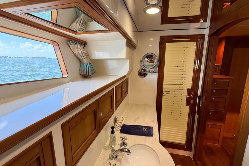 Slide: The Image of Luxurious Marlow 53E 2018 yacht bathroom with ocean view, elegant wood finishes, and modern fixtures. - 74