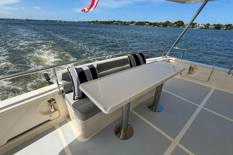 Slide: The Image of Outdoor seating area on 2018 Marlow 53E yacht with ocean view and table. - 8