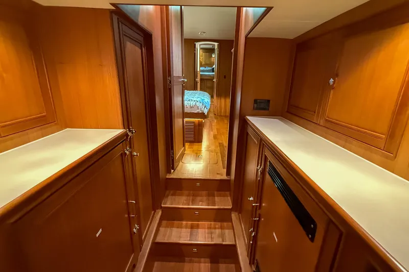 Slide: The Image of Luxurious wooden interior of 2018 Marlow 53E yacht, featuring elegant cabinetry and cozy hallway. - 81