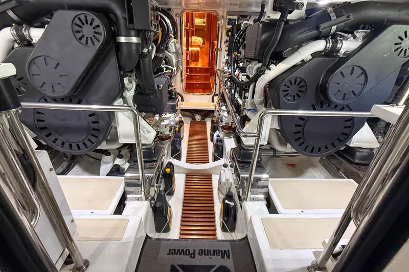 Slide: The Image of Engine room of 2018 Marlow 53E yacht, showcasing dual engines and mechanical systems. - 84