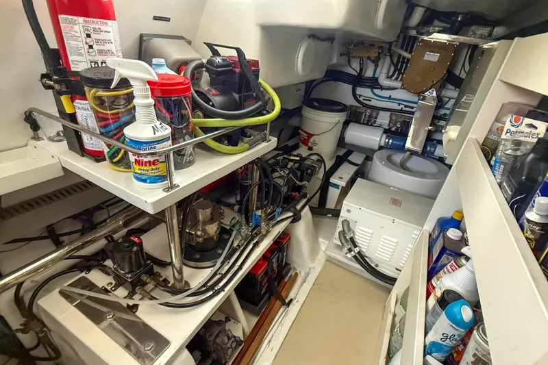 Slide: The Image of Engine room of a 2018 Marlow 53E yacht, featuring tools and maintenance supplies. - 86