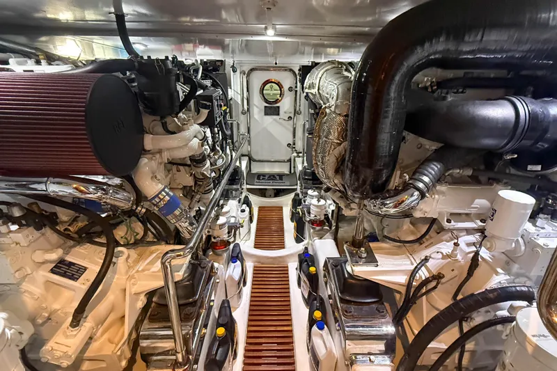 Slide: The Image of Engine room of a 2018 Marlow 53E yacht, showcasing detailed machinery and components. - 87