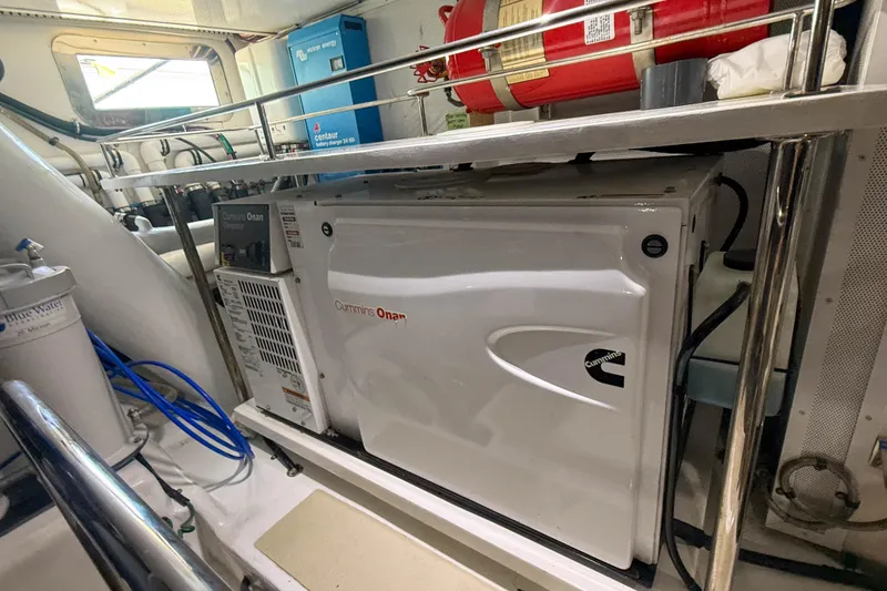 Slide: The Image of Engine room of 2018 Marlow 53E yacht with Cummins Onan generator and safety equipment. - 89