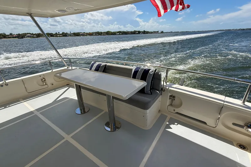 Slide: The Image of Luxury Marlow 53E yacht deck with seating, table, and ocean view, 2018 model. - 9