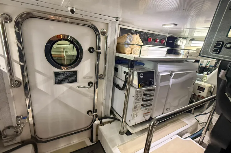 Slide: The Image of Engine room of 2018 Marlow 53E yacht with equipment and storage shelves. - 90